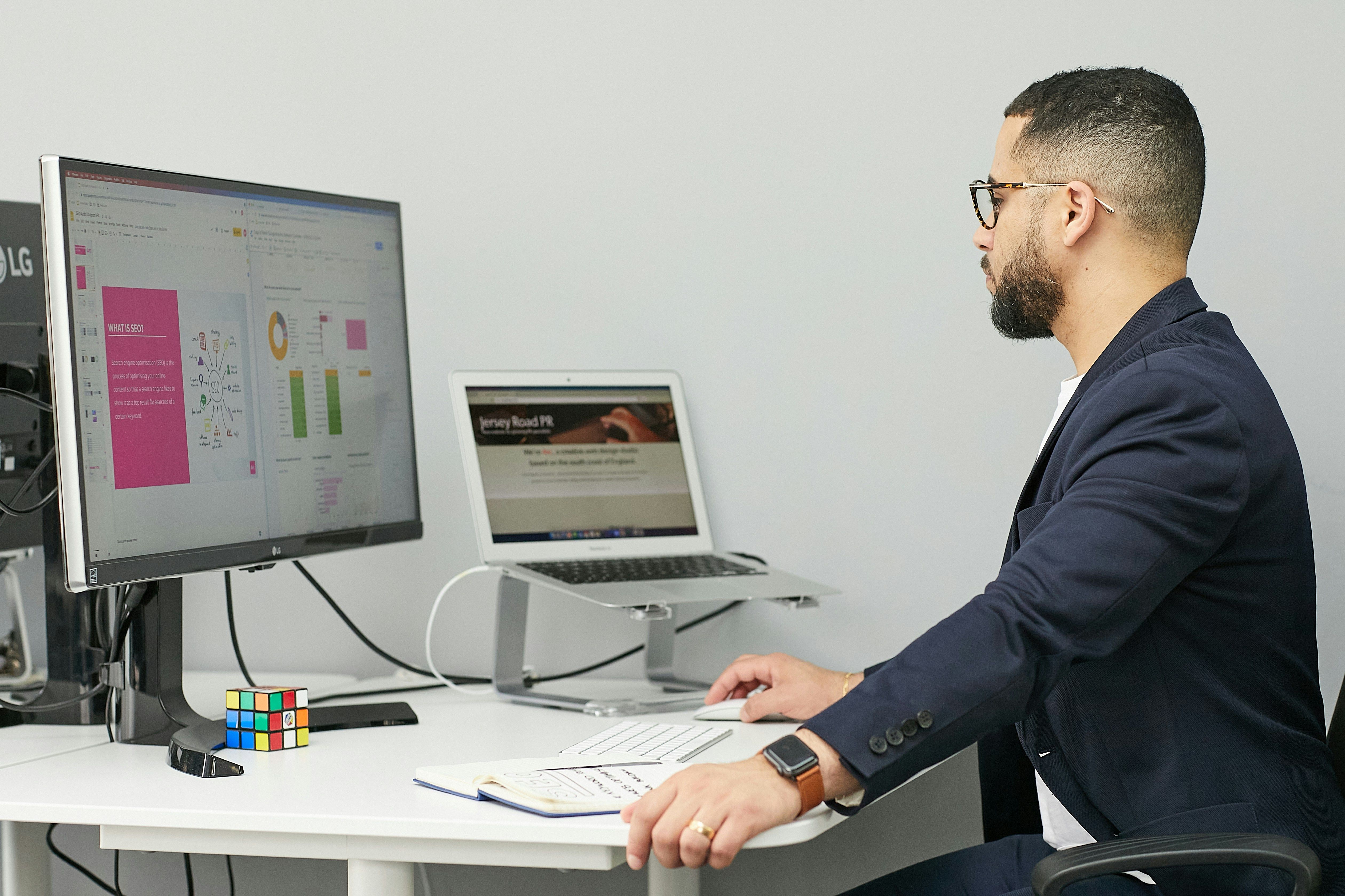 Professional accountant working at a clean desk with dual monitors